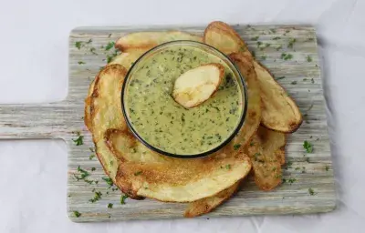 Callaloo Dip accompanied by potato chips