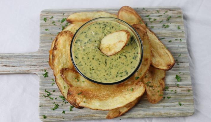 Callaloo Dip accompanied by potato chips